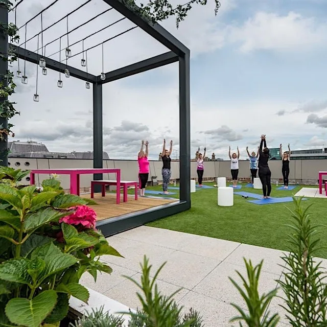 Yoga in secret roof garden over-looking Liverpool City Centre at Tempest Building